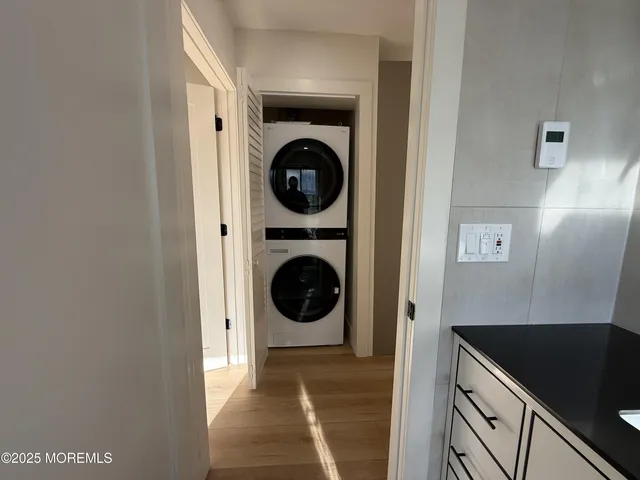 a view of a hallway with washer and dryer
