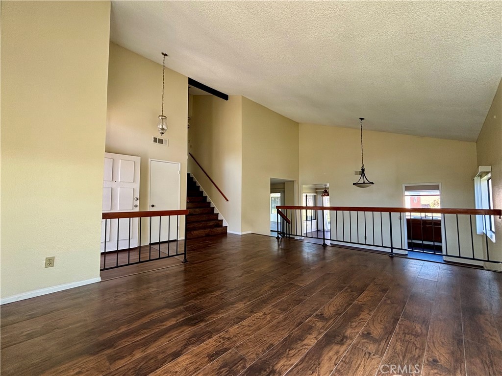 5715 Favela Drive Riverside, CA 92509 - Photo 18 of 27 a view of staircase with wooden floor and a rug