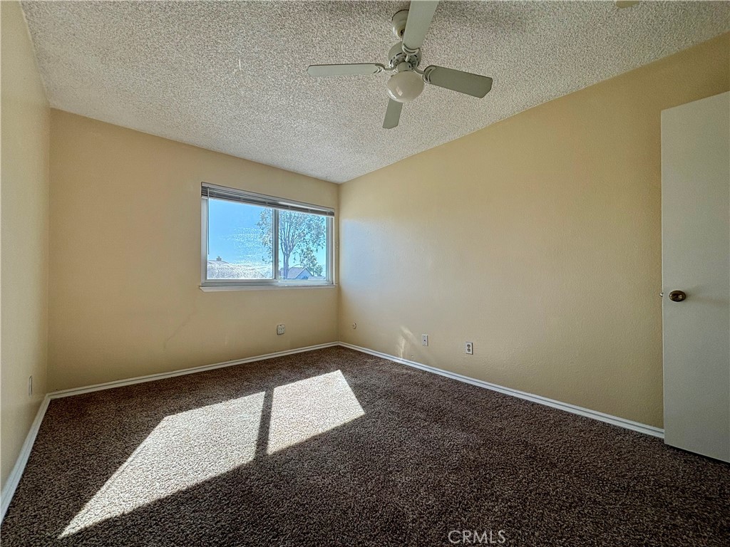 5715 Favela Drive Riverside, CA 92509 - Photo 22 of 27 an empty room with windows and fan