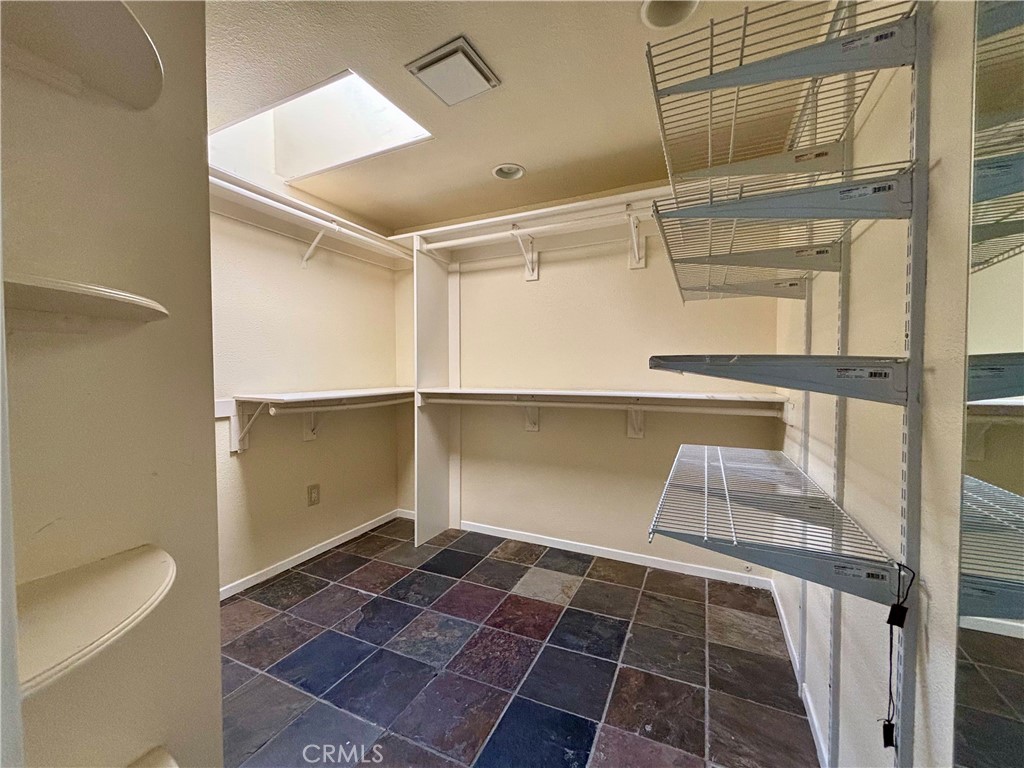 5715 Favela Drive Riverside, CA 92509 - Photo 25 of 27 a view of walk in closet with empty racks