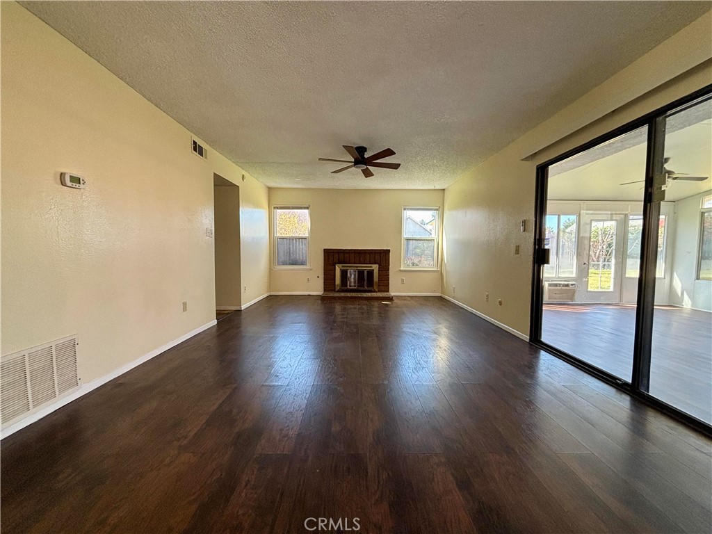 5715 Favela Drive Riverside, CA 92509 - Photo 27 of 27 a view of a livingroom with wooden floor and a ceiling fan