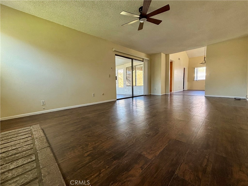 5715 Favela Drive Riverside, CA 92509 - Photo 6 of 27 a view of an empty room with a window and wooden floor
