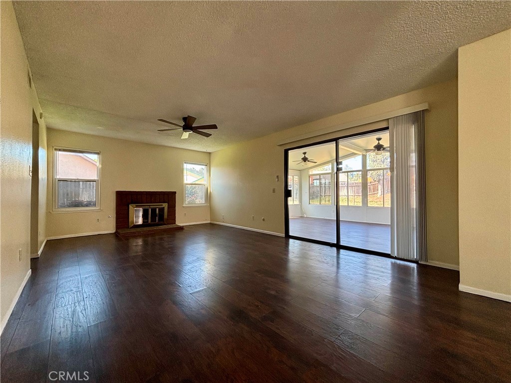 5715 Favela Drive Riverside, CA 92509 - Photo 7 of 27 a view of empty room with wooden floor and fireplace
