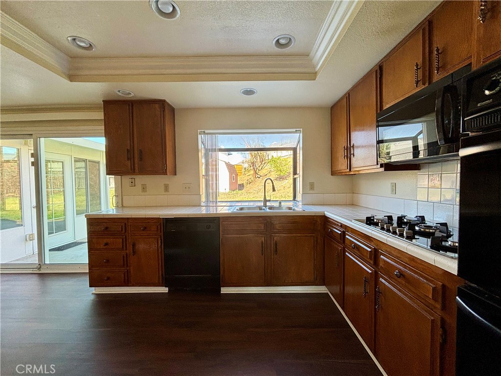 5715 Favela Drive Riverside, CA 92509 - Photo 10 of 27 a kitchen with stainless steel appliances granite countertop a stove and a refrigerator