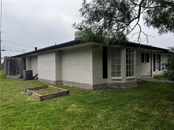 a view of a backyard with a garden and plants