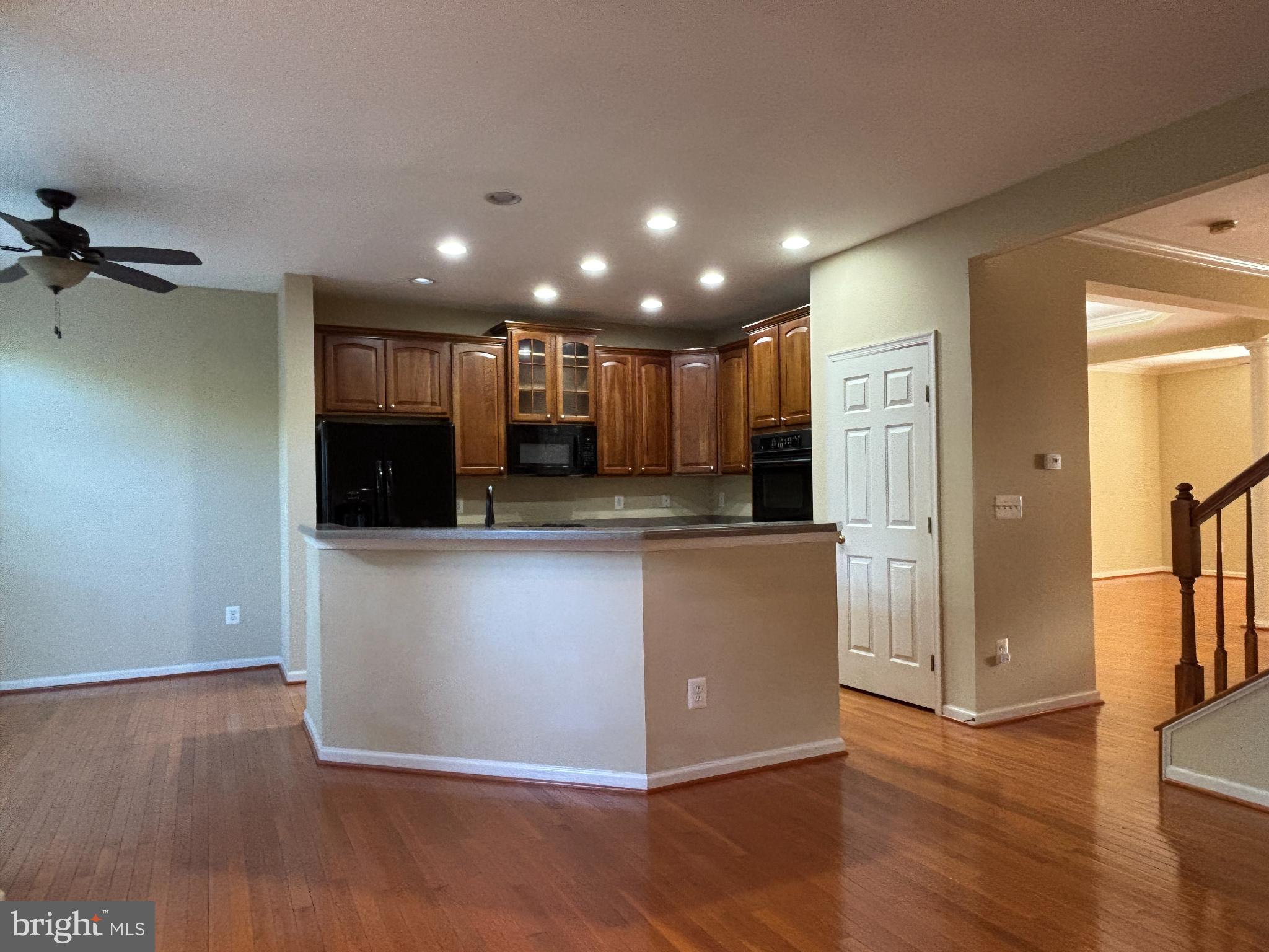 1538 Grosbeak Court Woodbridge, VA 22191 - Photo 2 of 39 a view of kitchen with kitchen island wooden floor center island and stainless steel appliances