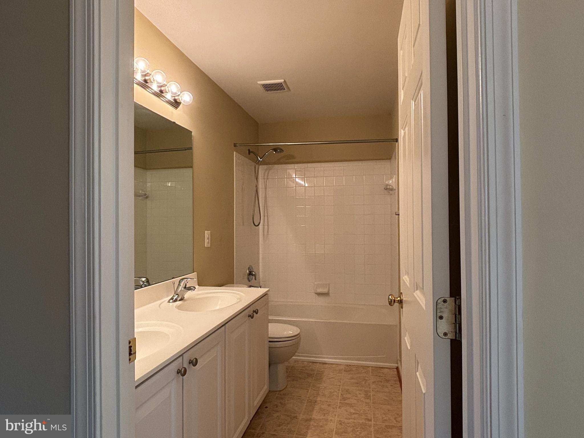 1538 Grosbeak Court Woodbridge, VA 22191 - Photo 24 of 39 a bathroom with a double vanity sink and mirror with shower