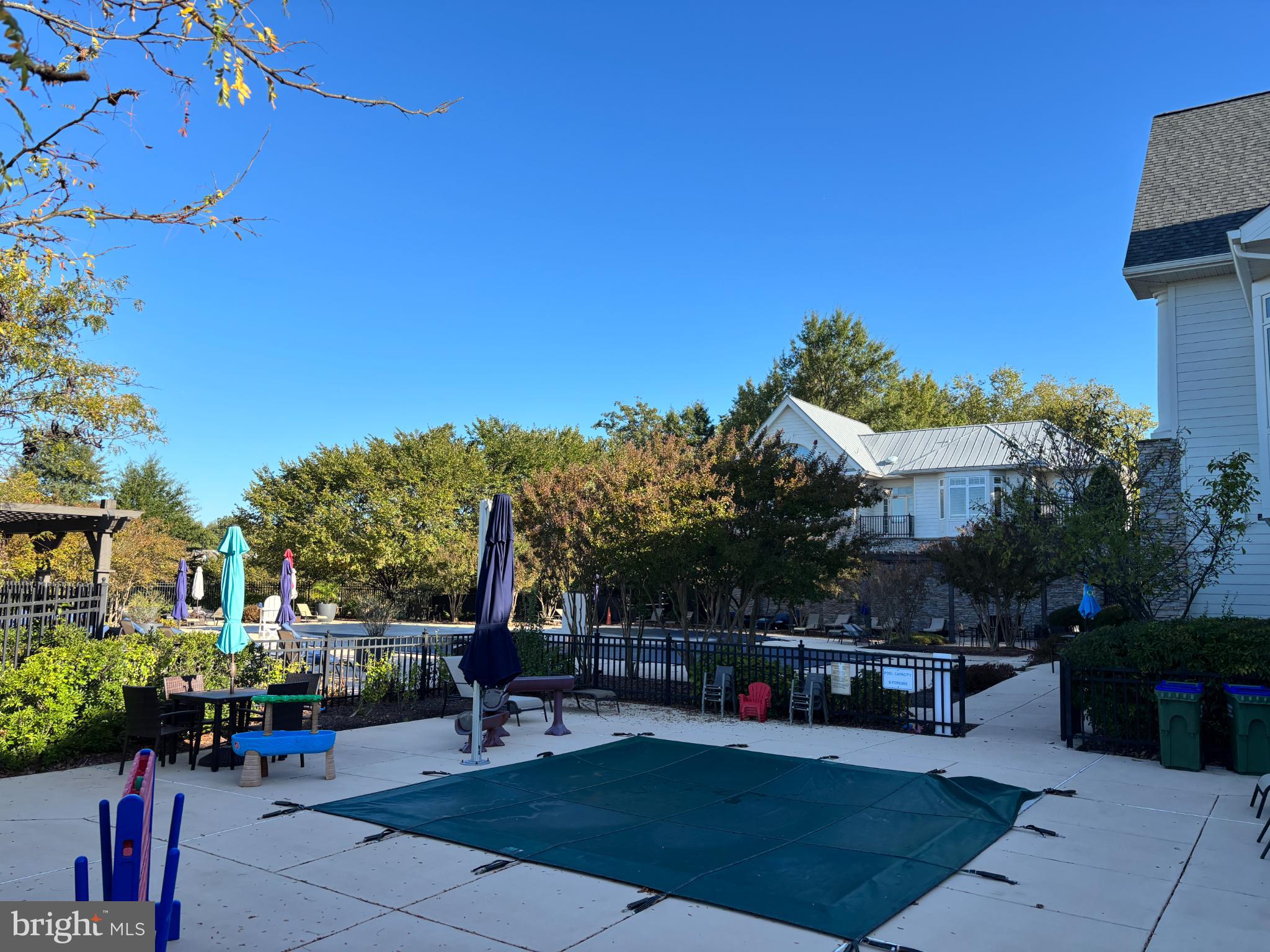 1538 Grosbeak Court Woodbridge, VA 22191 - Photo 38 of 39 a view of a patio with couches and table and chairs with potted plants and big trees