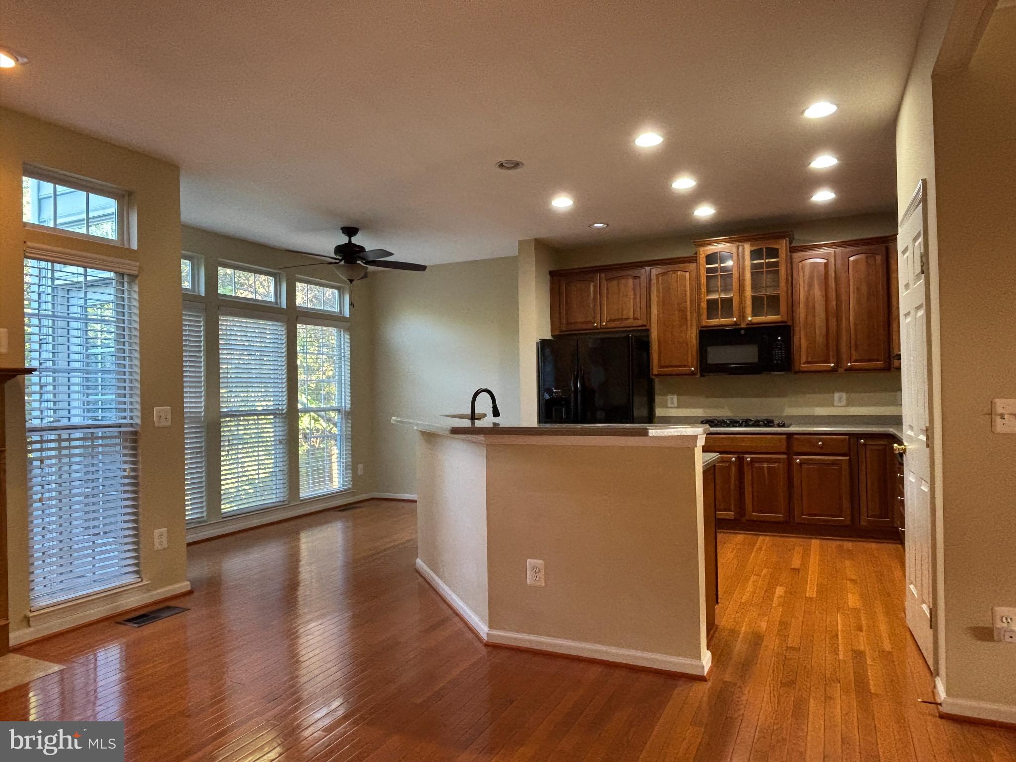 1538 Grosbeak Court Woodbridge, VA 22191 - Photo 7 of 39 a kitchen with stainless steel appliances granite countertop a refrigerator a sink dishwasher a stove and a large countertops with wooden floor