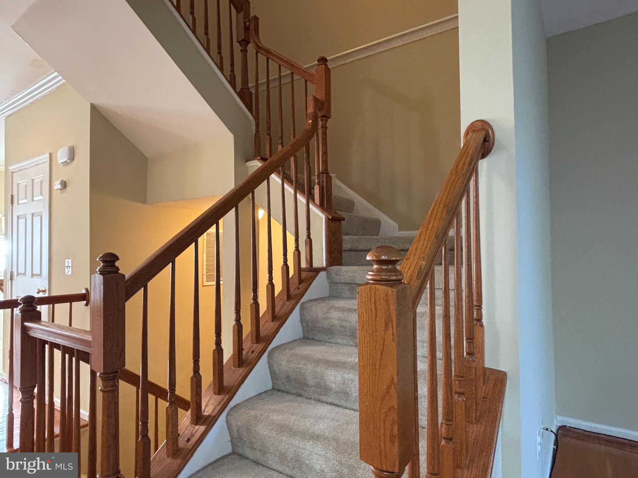 1538 Grosbeak Court Woodbridge, VA 22191 - Photo 10 of 39 a view of staircase with lots of frames on wall and wooden floor
