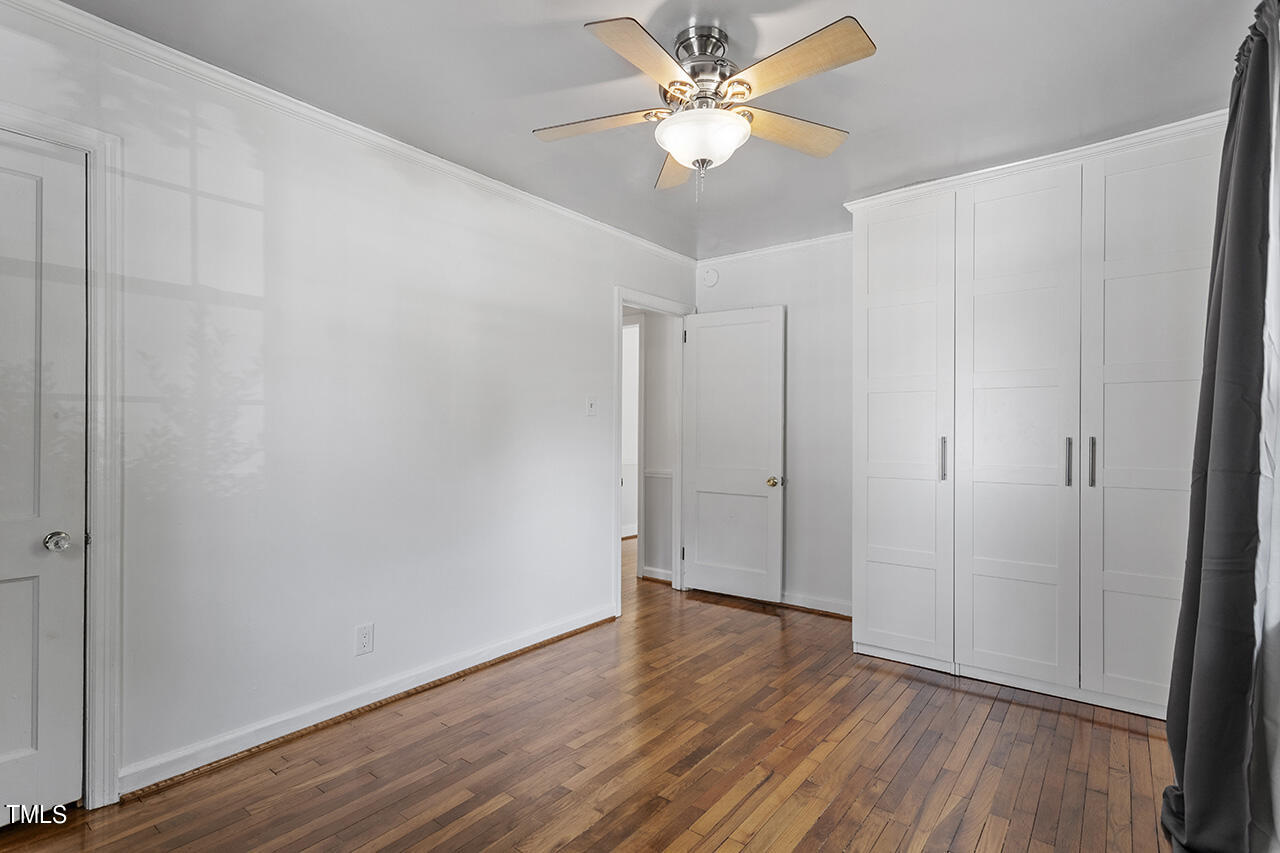 1716 Bennett Street Raleigh, NC 27604 - Photo 15 of 30 an empty room with wooden floor fan and windows