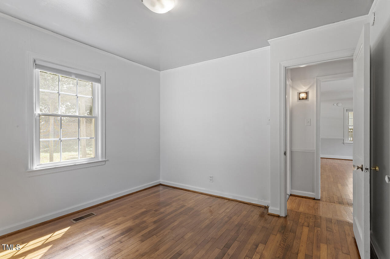 1716 Bennett Street Raleigh, NC 27604 - Photo 19 of 30 an empty room with wooden floor and a window
