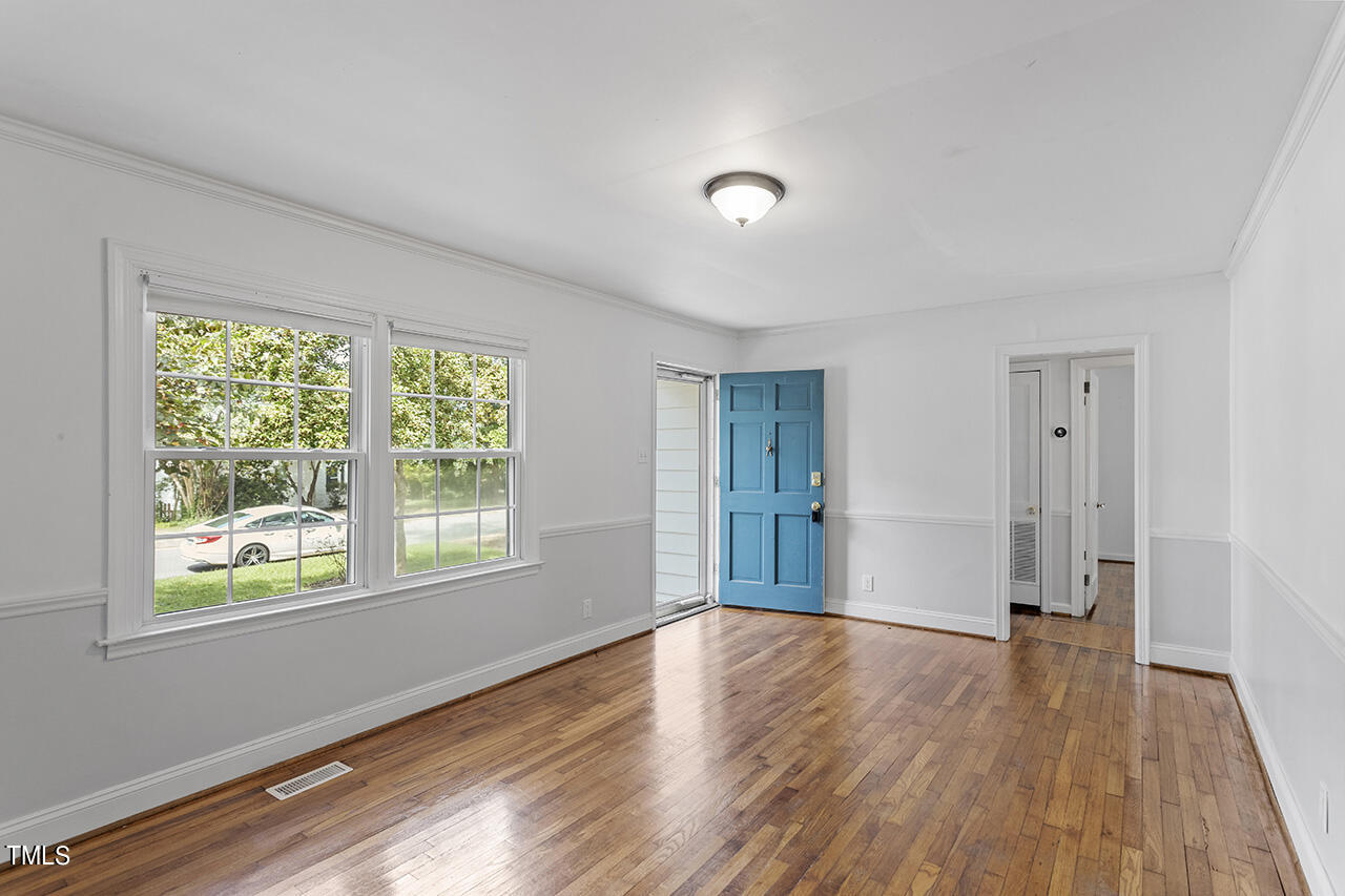 1716 Bennett Street Raleigh, NC 27604 - Photo 2 of 30 a view of an empty room with wooden floor and a window