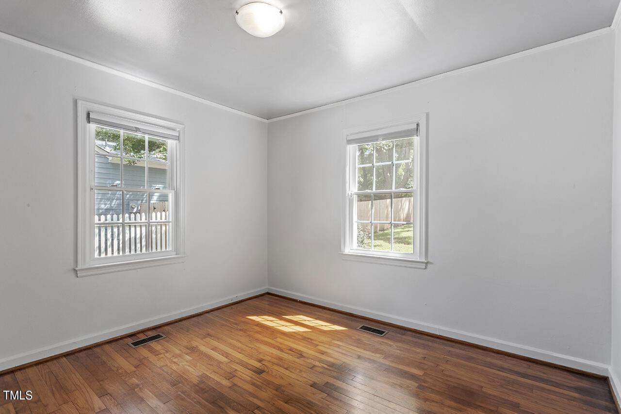 1716 Bennett Street Raleigh, NC 27604 - Photo 21 of 30 a view of an empty room with wooden floor and a window