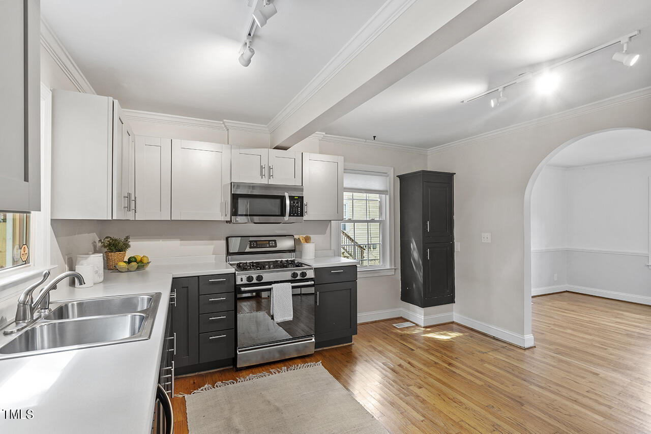 1716 Bennett Street Raleigh, NC 27604 - Photo 7 of 30 a kitchen with stainless steel appliances granite countertop a sink dishwasher stove top oven and refrigerator
