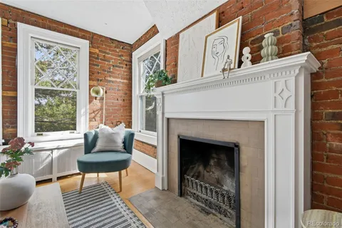 a living room with furniture a window and a fireplace