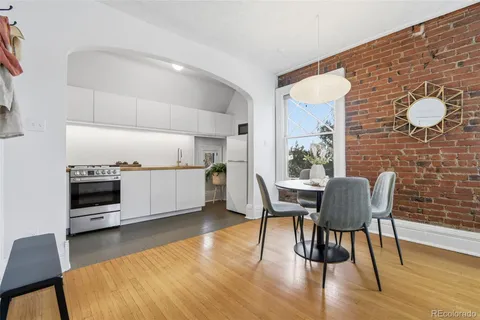 a view of a dining room with furniture and wooden floor