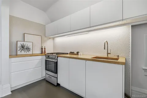 a kitchen with stainless steel appliances white cabinets and a sink