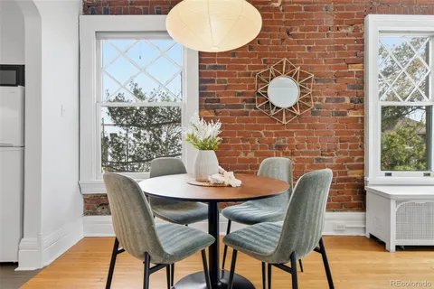 a dining room with furniture and wooden floor
