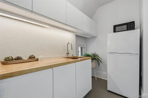 a kitchen with a refrigerator and a sink