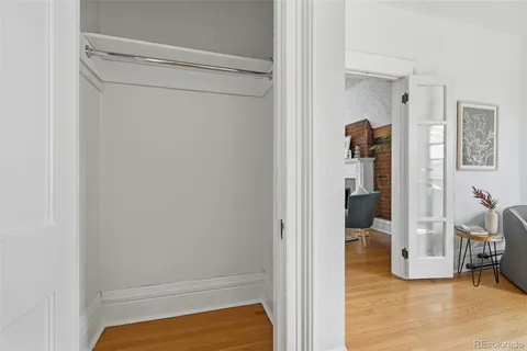 a view of walk in closet with clothes and shoes
