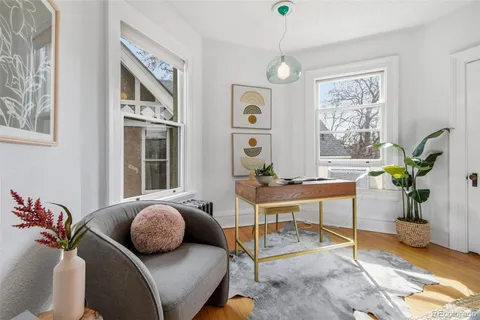 a living room with furniture a chandelier and a window