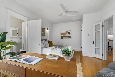 a dining room with furniture and a potted plant