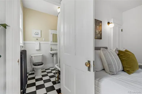 a bathroom with a sink and mirror with toilet