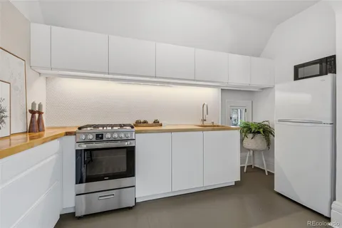 a utility room with cabinets washer and dryer