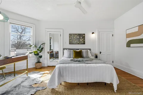 a bedroom with a bed and wooden floor