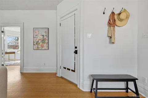 a view of a hallway with wooden floor and workspace