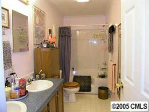 7923 Walkup Road Waxhaw, NC 28173 - Photo 5 of 8 a bathroom with a granite countertop sink and a mirror