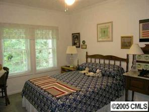 7923 Walkup Road Waxhaw, NC 28173 - Photo 7 of 8 a bedroom with a bed and wooden floor