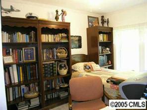 7923 Walkup Road Waxhaw, NC 28173 - Photo 8 of 8 a bed sitting in a bedroom next to a book shelf