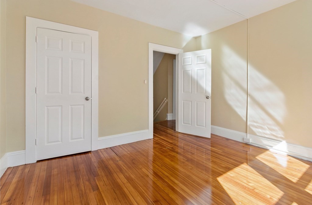 383 White Street Springfield, MA 01108 - Photo 12 of 39 a view of an empty room with wooden floor and a window