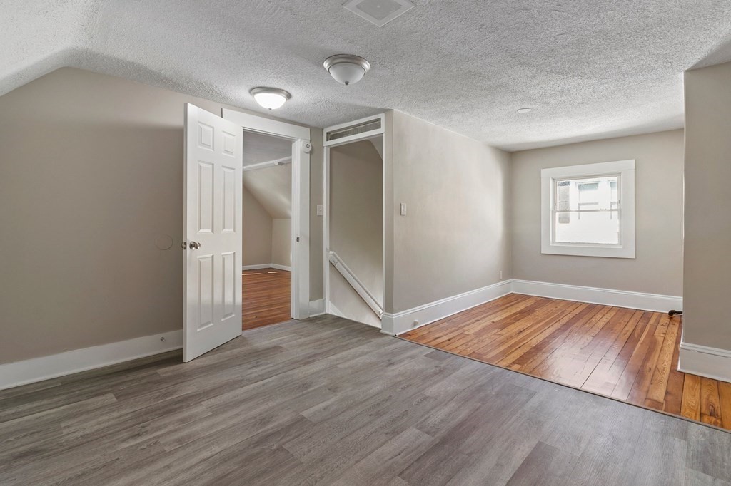 383 White Street Springfield, MA 01108 - Photo 15 of 39 an empty room with wooden floor and windows