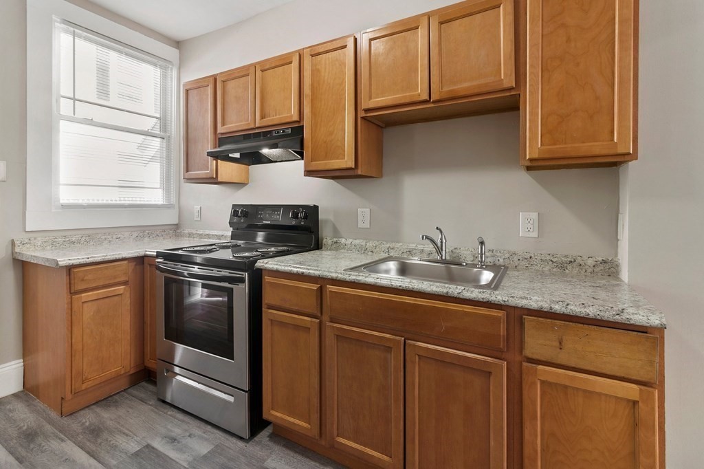 383 White Street Springfield, MA 01108 - Photo 17 of 39 a kitchen with granite countertop cabinets stainless steel appliances and a sink