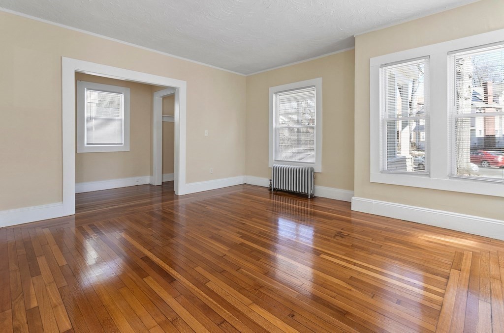 383 White Street Springfield, MA 01108 - Photo 20 of 39 an empty room with wooden floor and windows