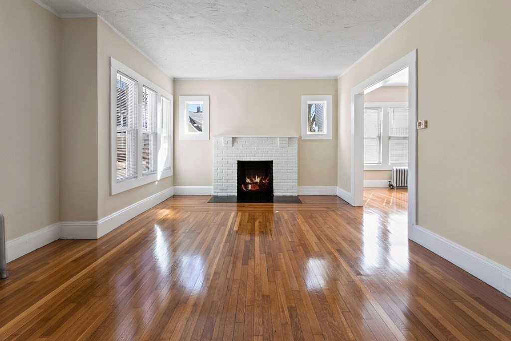 383 White Street Springfield, MA 01108 - Photo 22 of 39 a view of an empty room with wooden floor fireplace and a window