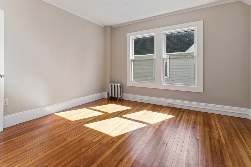 383 White Street Springfield, MA 01108 - Photo 26 of 39 an empty room with wooden floor and windows