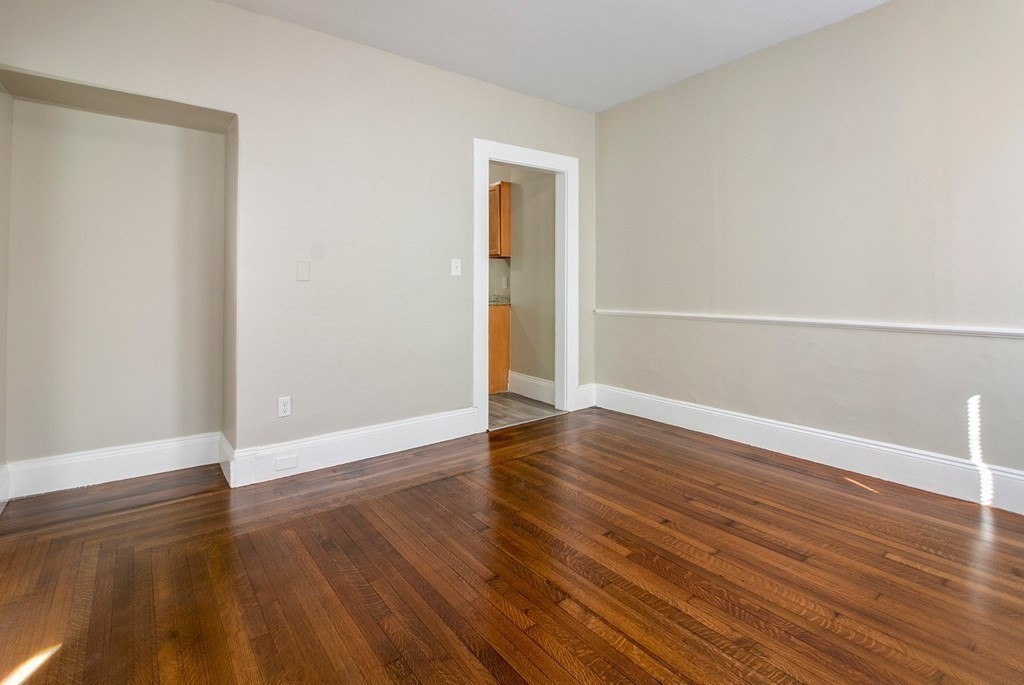 383 White Street Springfield, MA 01108 - Photo 28 of 39 a view of an empty room with wooden floor and a window