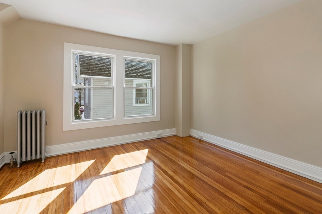 383 White Street Springfield, MA 01108 - Photo 29 of 39 an empty room with wooden floor and windows