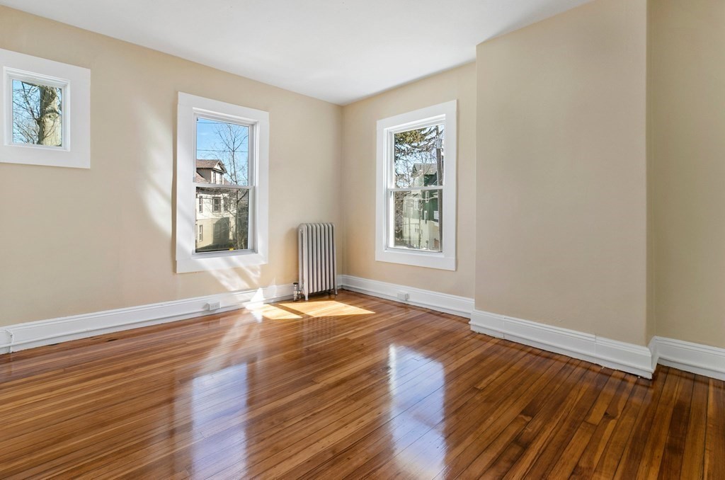 383 White Street Springfield, MA 01108 - Photo 35 of 39 a view of an empty room with wooden floor and a window