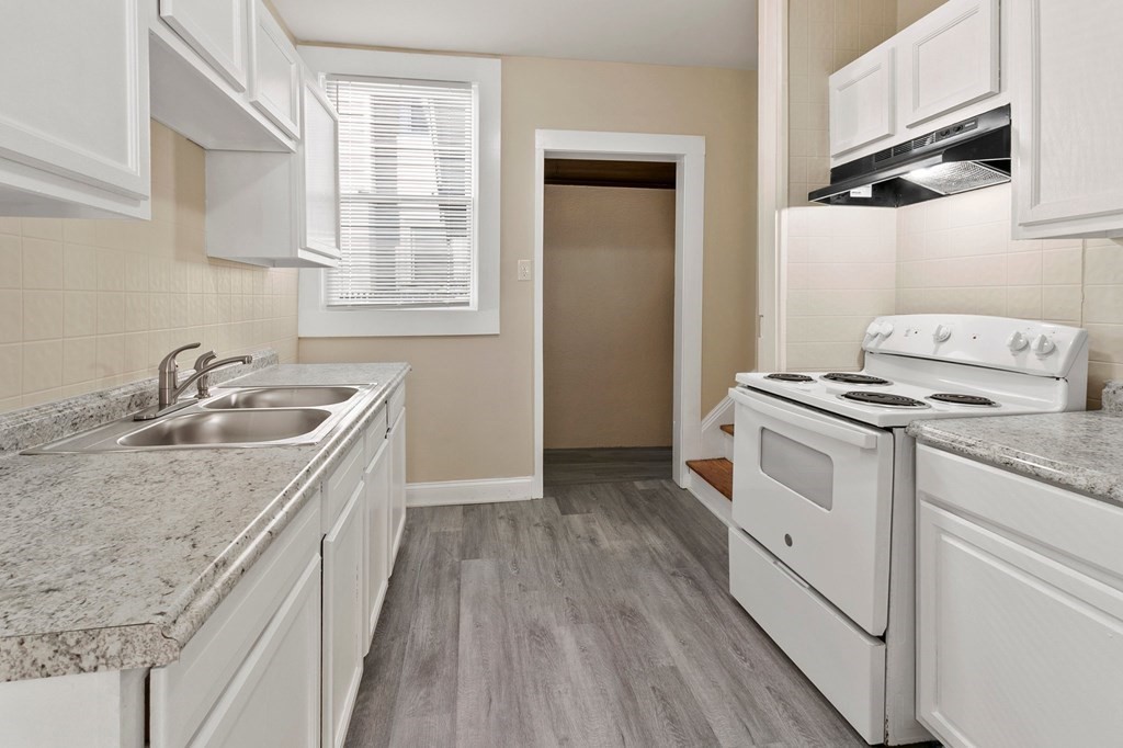 383 White Street Springfield, MA 01108 - Photo 5 of 39 a kitchen that has a sink a stove and wooden floor