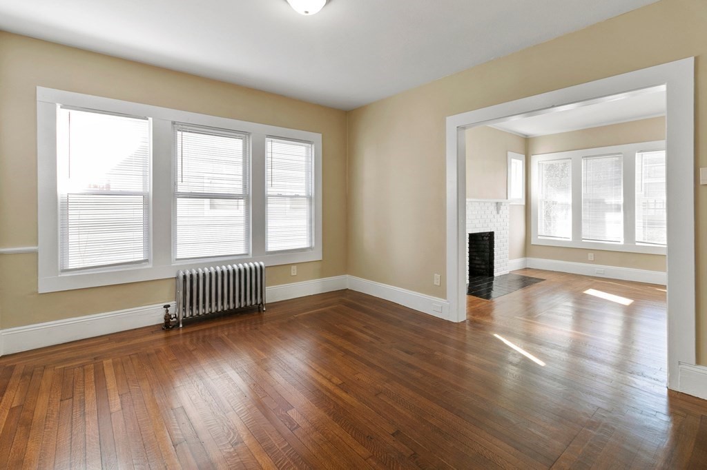 383 White Street Springfield, MA 01108 - Photo 7 of 39 an empty room with wooden floor and windows