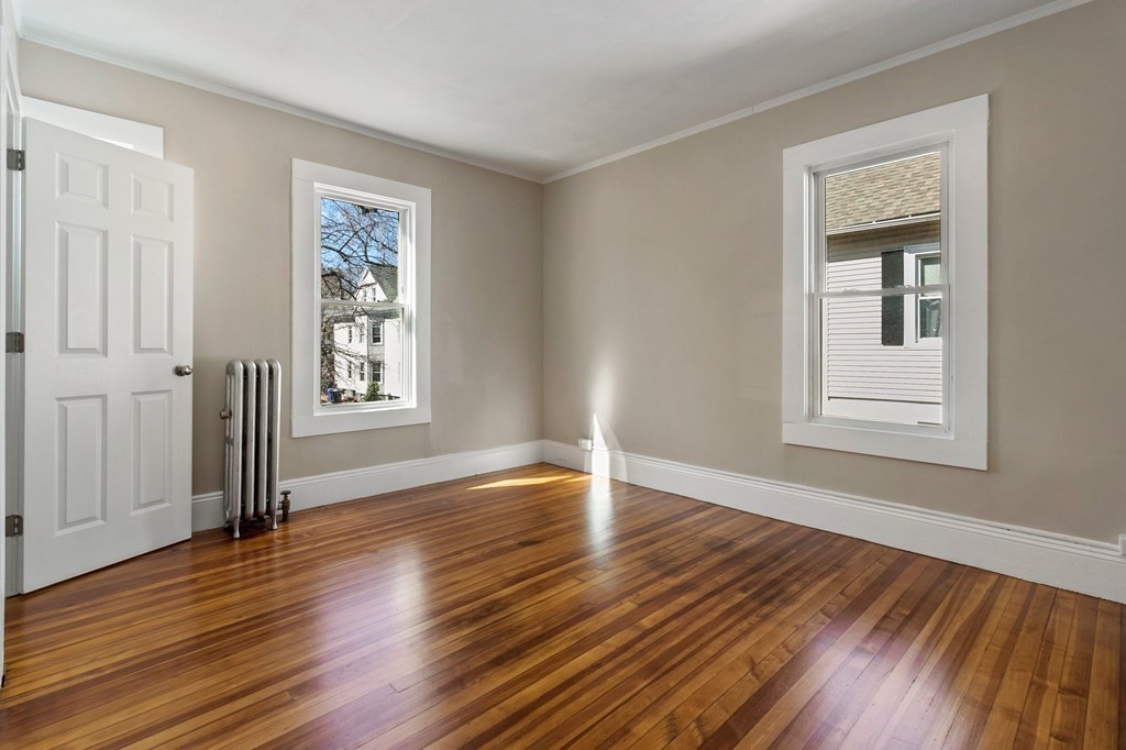 383 White Street Springfield, MA 01108 - Photo 9 of 39 a view of an empty room with wooden floor and a window