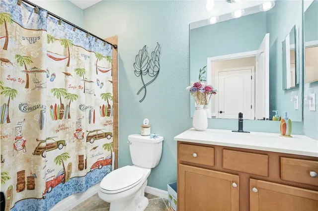 a bedroom with a bed and a lamp on table