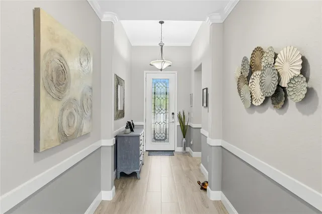 a hallway with furniture and wooden floor