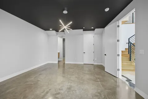 a view of a living room with workspace and a refrigerator