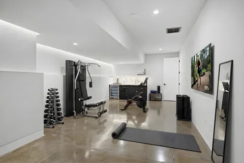 a living room with furniture and large windows